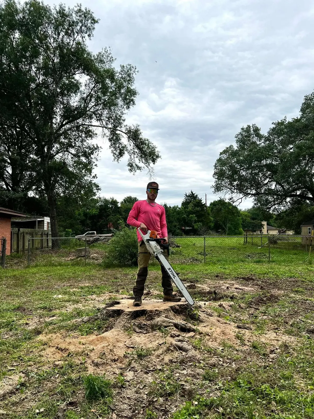 Crew member at a completed residential tree-removal work area