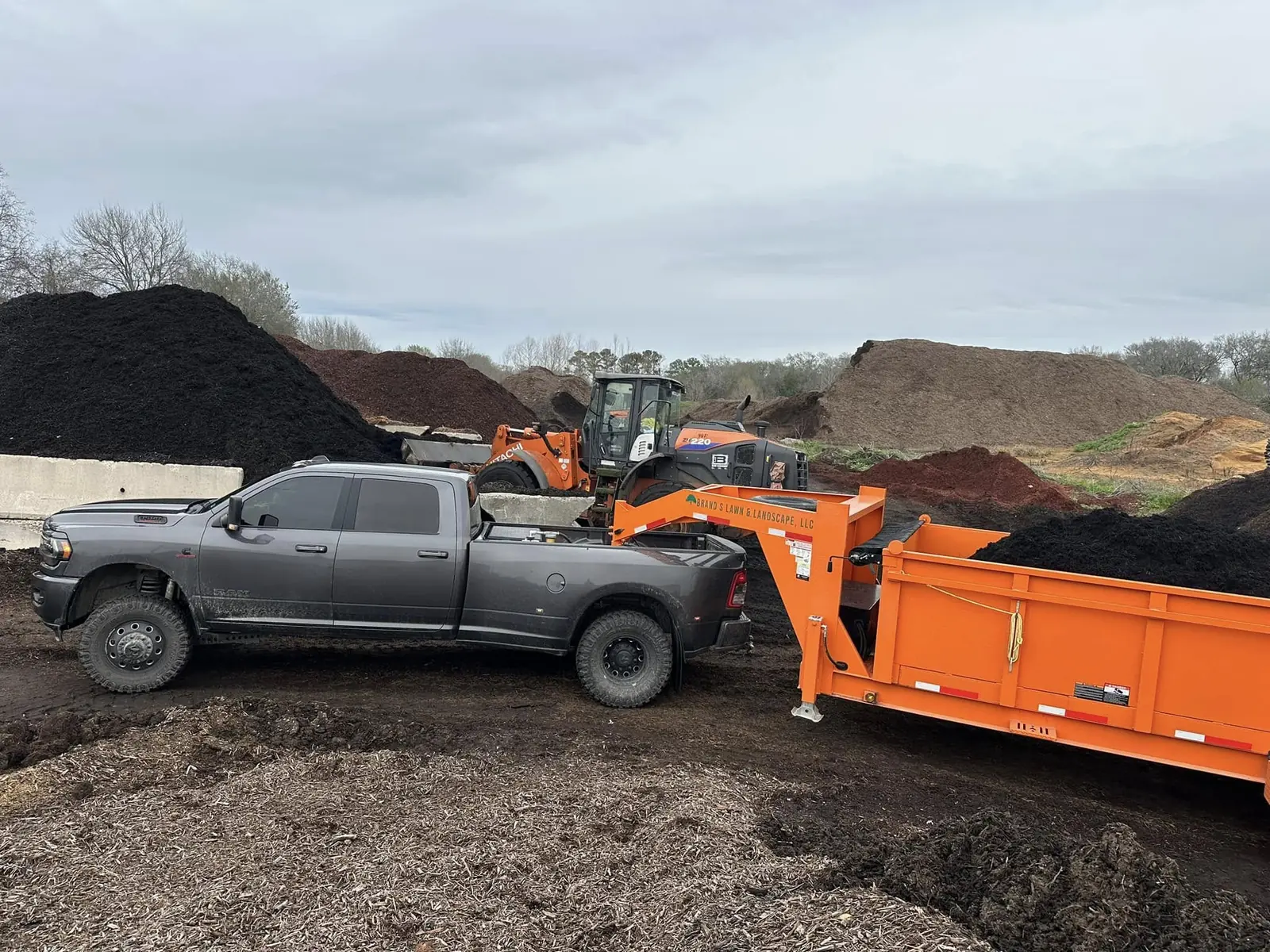 Brand S truck and trailer collecting bulk landscape material