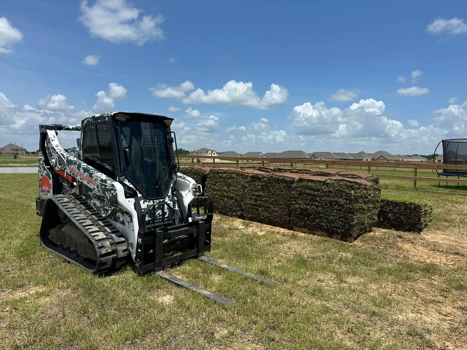 Brand S skid steer staging sod for a residential landscape installation