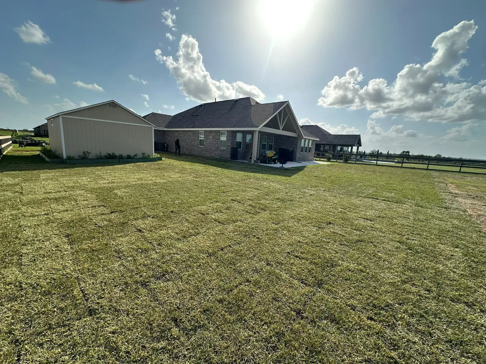 Newly installed sod across a large residential backyard