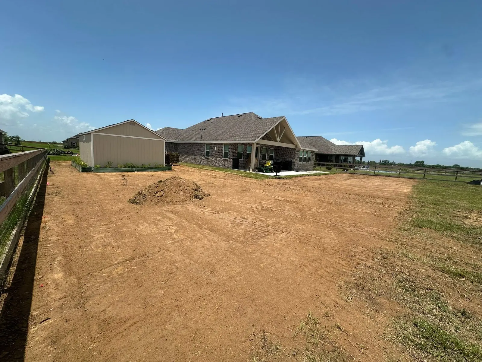Residential backyard graded and prepared for sod installation